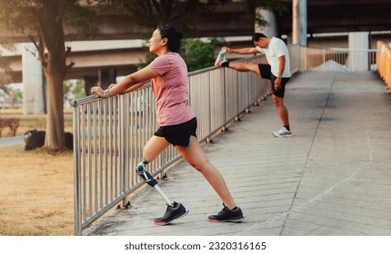 Athlete with prosthetic leg doing warm up exercise on park. Woman wearing prosthetic equipment for jogging. Female with prosthesis of leg - Powered by Shutterstock