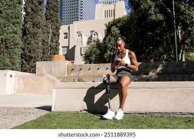 Athlete with prosthetic leg using smartphone - Powered by Shutterstock