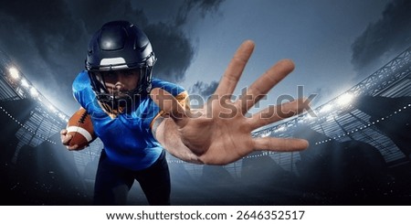 Athlete in protective gear blocking with hand, holding ball in 3D American football field. Concept of fitness and energy themed campaigns, athlete performance