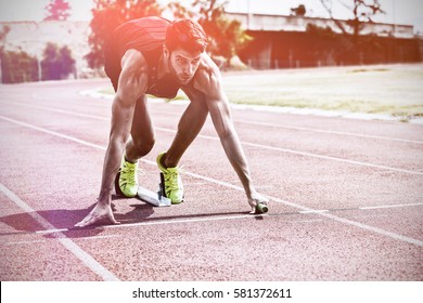 Athlete Ready To Start Relay Race On Running Track