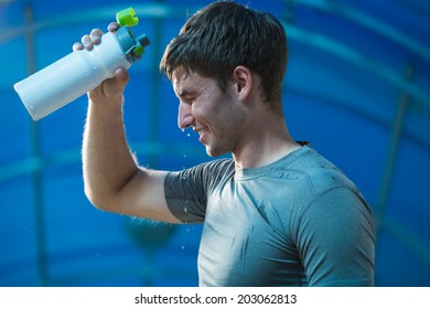 Athlete is refreshing himself with water