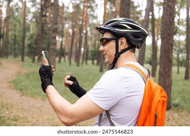 Athlete Relaxing After Intensive Workout. Cyclist Using Smartphone When Rest. Athlete Using Smartphone And Texting With Friends.Cyclist Resting After Riding Bicycle Ride And Chatting On Social Network - Powered by Shutterstock