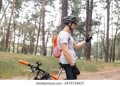 Athlete Relaxing After Intensive Workout. Cyclist Using Smartphone When Rest. Athlete Using Smartphone And Texting With Friends.Cyclist Resting After Riding Bicycle Ride And Chatting On Social Network - Powered by Shutterstock