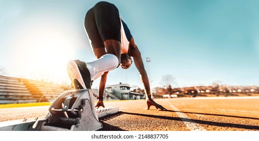 Athlete runner feet running on treadmill closeup on shoe - Track and field runner in sport uniform at starting position - Fitness lifestyle, sport and healthy concept - Powered by Shutterstock