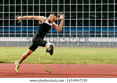 athlete runner physically disabled run on track of stadium