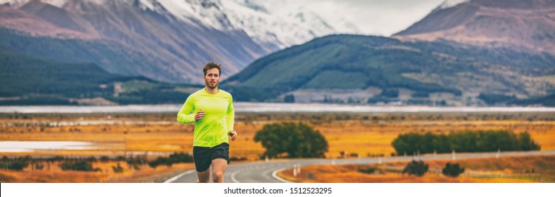 Athlete Runner Running In Mountain Landscape In Panoramic Banner Background. Man Run Exercise Long Distance Training Outdoor In Cold Autumn Weather.