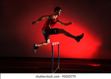  Athlete Running Hurdles Isolated On Red Background