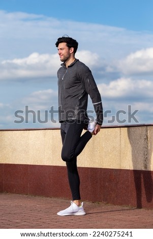 Athlete Running Male Runner During Sporty Fit Young Man Jogging by River Bank And Bridge As Jogger Training While Stretching.Vertical Shot