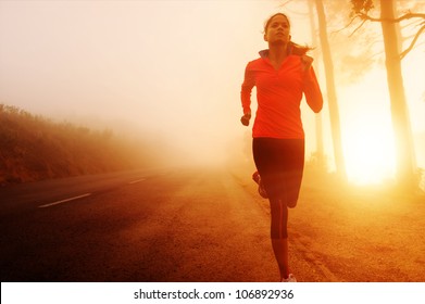 Athlete running on the road in morning sunrise training for marathon and fitness. Healthy active lifestyle latino woman exercising outdoors. - Powered by Shutterstock