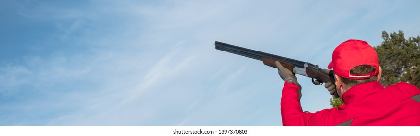 athlete shoots a clay pigeon with a double-barreled hunting rifle, skeet shooting, copy space