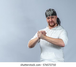 The Athlete In A Suit For Practicing Capoeira Shows Friendliness, Light-blue Background