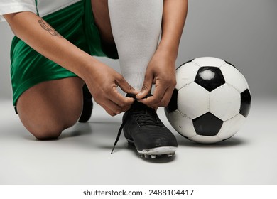 An athlete ties her cleats before a football match. - Powered by Shutterstock