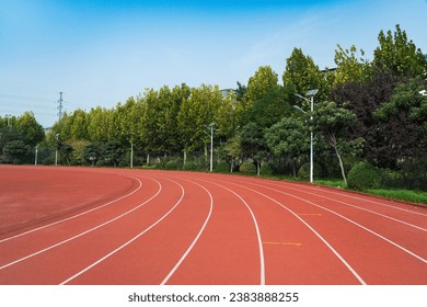 Athlete track or running track with green trees in the playground
