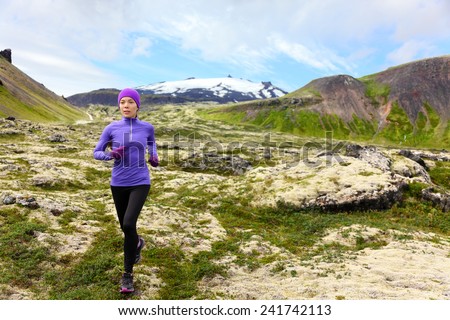 Athlete trail runner - running woman exercising. Fit female sport fitness model training jogging outdoors living healthy lifestyle in beautiful mountain nature, Snaefellsjokull, Snaefellsnes, Iceland.