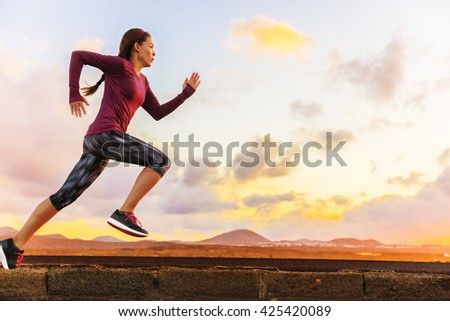Athlete trail running silhouette of a woman runner at sunset sunrise. Cardio fitness training of marathon race sportswoman. Active healthy lifestyle in summer nature outdoors.