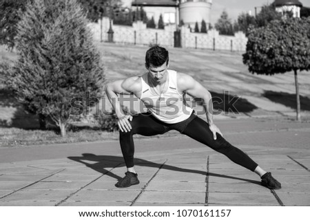 Similar – Athletic man warming up before running.