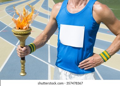 Athlete Wearing Blank Race Bib Holding Sport Torch In Front Of Running Track