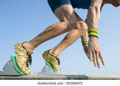 Athlete Wearing Gold Running Shoes Takes Off In A Blur From From The Race Track Starting Blocks 