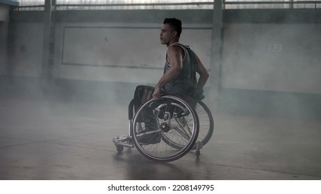 Athlete In Wheelchair With Disability Grabbing Ball And Passing To Team Member. Disabled Person Training Sport