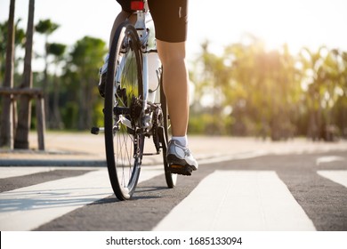 Athlete Woman Cyclist Legs Riding Mountain Bike On The Road In The Morning.