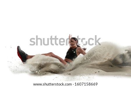 Athlete woman doing a long jump isolated on white background.