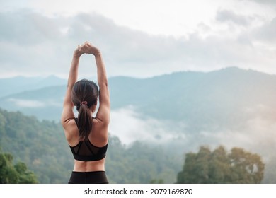 athlete woman exercise in morning, Young fitness woman stretching muscle against mountain view, warm up ready for running or jogging. Workout, wellbeing and sport girl concepts
