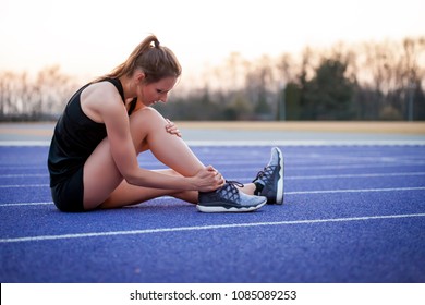 Athlete woman has ankle injury, sprained leg during running training
