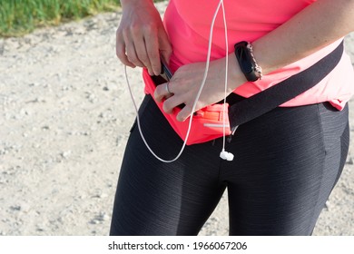 Athlete Woman Keeping The Mobile In Her Pink Fanny Pack.