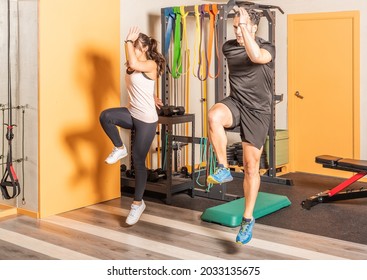 Athlete Woman And Man Doing Lunges Jump Exercises For Leg Muscle Workout.