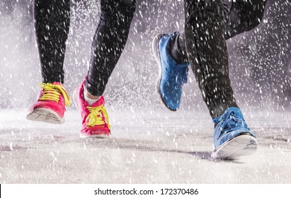 Athlete Woman And Man Are Running During Winter Training Outside In Cold Snow Weather.