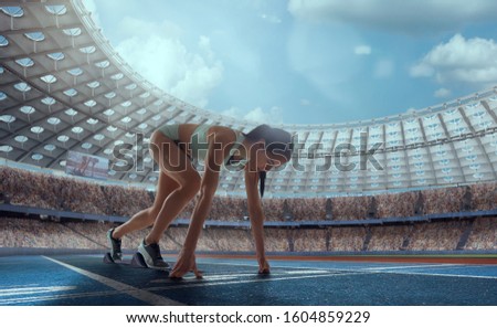 Athlete woman on the starting blocks on sport championship.