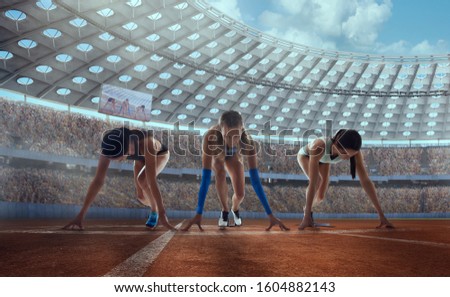 Athlete woman on the starting blocks on the sports competition.