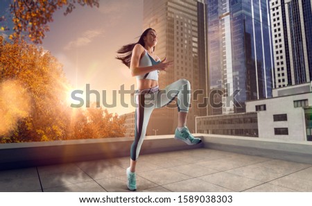 Athlete woman run on the city street. Sport tight clothes. Bright sunset, city background. Horizontal.