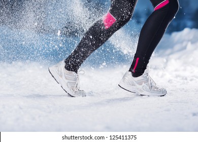 Athlete Woman Is Running During Winter Training Outside In Cold Snow Weather.