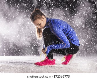 Athlete Woman Is Running During Winter Training Outside In Cold Snow Weather.