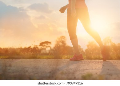 Athlete woman walking exercise on rural road in sunset background, healthy and lifestyle concept - Shutterstock ID 793749316