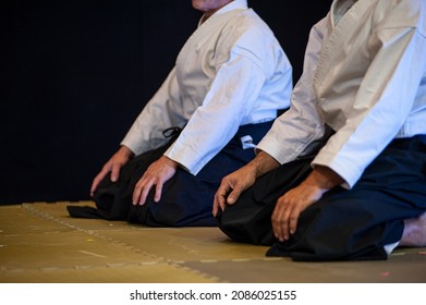 Athletes of Aikido (black belt) kneeling in Seiza position. - Shutterstock ID 2086025155