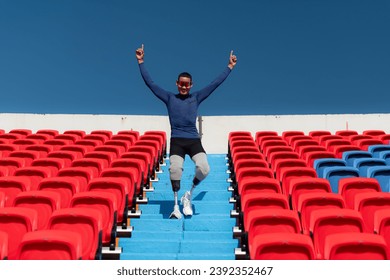 Athletes with disabilities cheer from the stands in a sports arena. - Shutterstock ID 2392352467