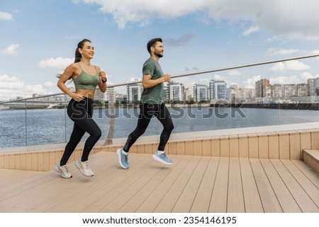Athletes exercise for health. Happy people jogging together. Runners partners workout in fitness clothes and running shoes.  Use a sports watch and a cardio app.