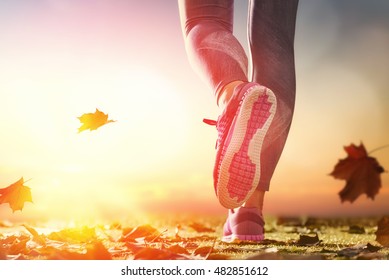 athlete's foots close-up on autumn walk in nature outdoors. healthy lifestyle and sport concepts.