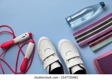 Athlete's Kit On A Blue Flatlay Background. The Concept Of A Healthy Lifestyle, Sports And Diet. Horizontal Orientation, Top View, Copy Space, No People. Unisex Sports, Men's And Women's Fitness.