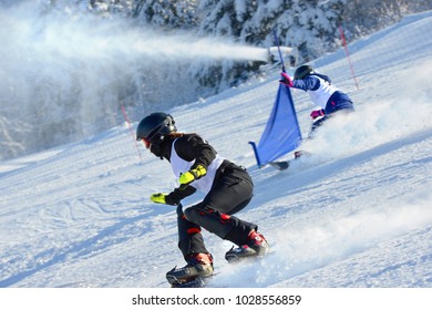 Athletes On A Snowboarding Slalom