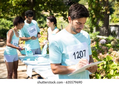 Athletes registering themselves for marathon in the park - Powered by Shutterstock