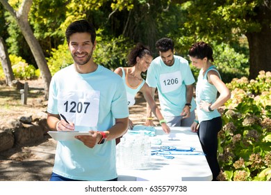 Athletes registering themselves for marathon in the park - Powered by Shutterstock