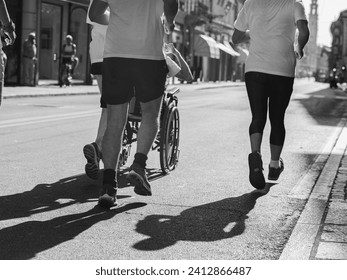 Athletes Runners and Boy in a Wheelchair during Sport Marathon. - Powered by Shutterstock