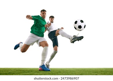 Athletes, soccer player in white stretches to defend against player in green's powerful kick on green lash playground against white background. Concept of sport, championship, final match, movement. - Powered by Shutterstock