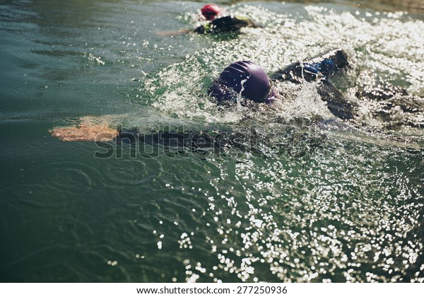 Athletes swimming in a competition. Open\
water swimming, athletes swimming long\
distance.