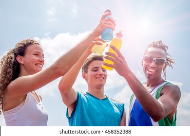 Athletes Taking A Break After Training Drinking Colorful Energy Drink Or Sports Drink - Concept Of Sports People Consuming Energetic Beverages