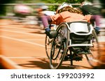 Athletes  at a wheelchair race in a stadium with motion blur and lens vignetting