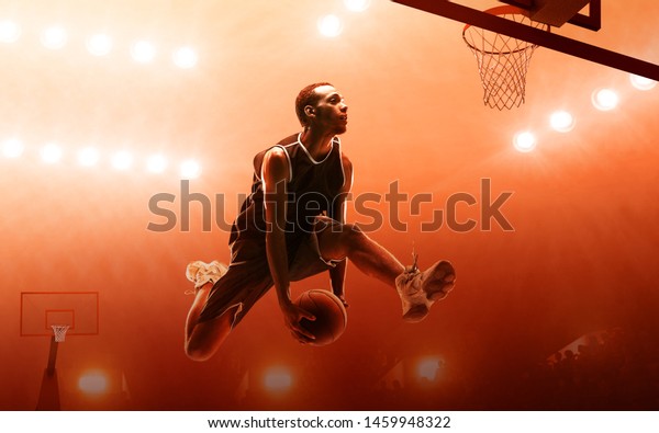 プロバスケットボールの試合中にレイアップバスケットを得点するアフリカ系アメリカ人のスポーツ選手 赤い投光背景 の写真素材 今すぐ編集